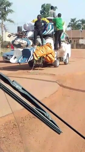 Overloaded truck carries furniture on Nigerian road