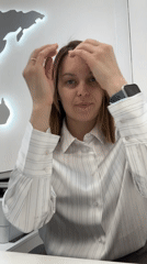 Woman in striped shirt observed at desk workspace