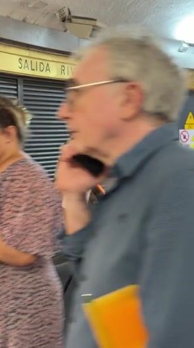Harpist performs in Barcelona subway station during evening rush