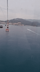 Cable car passenger films ocean views in Nha Trang