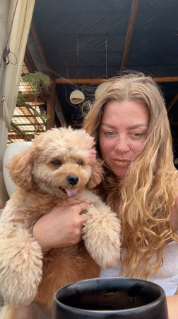 Woman poses with small dog in outdoor Indonesia photoshoot