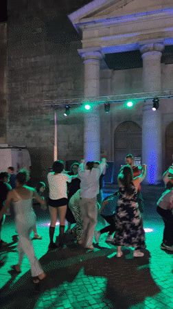 Summer night dance event outside a French town hall