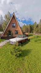Vintage car and A-frame house, kids playing outside
