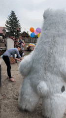 Families celebrate with polar bear mascot at backyard gathering