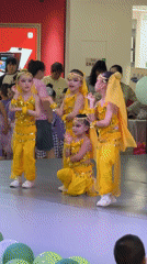 Children perform coordinated dance in yellow costumes at Chongqing mall