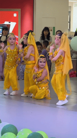 Children perform coordinated dance in yellow costumes at Chongqing mall