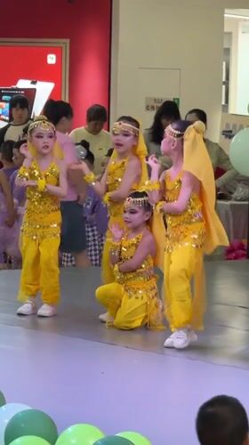 Children perform coordinated dance in yellow costumes at Chongqing mall