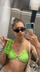 Woman enjoys Monster Energy drink during morning beach outing