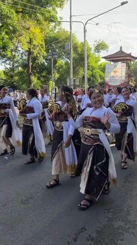 Traditional Balinese procession with costumed participants in Denpasar