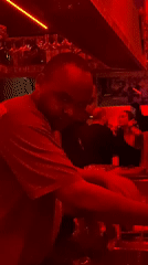 Bartender works at red-lit nightclub in Dubai