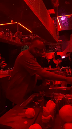Bartender works at red-lit nightclub in Dubai