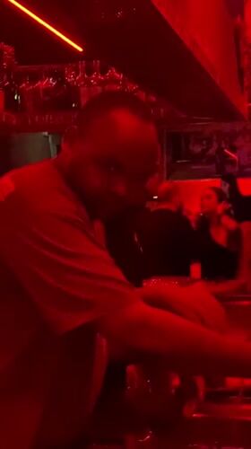 Bartender works at red-lit nightclub in Dubai