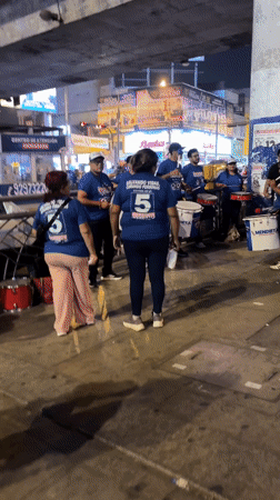 Street drummers gather with balloons in San Juan de Miraflores