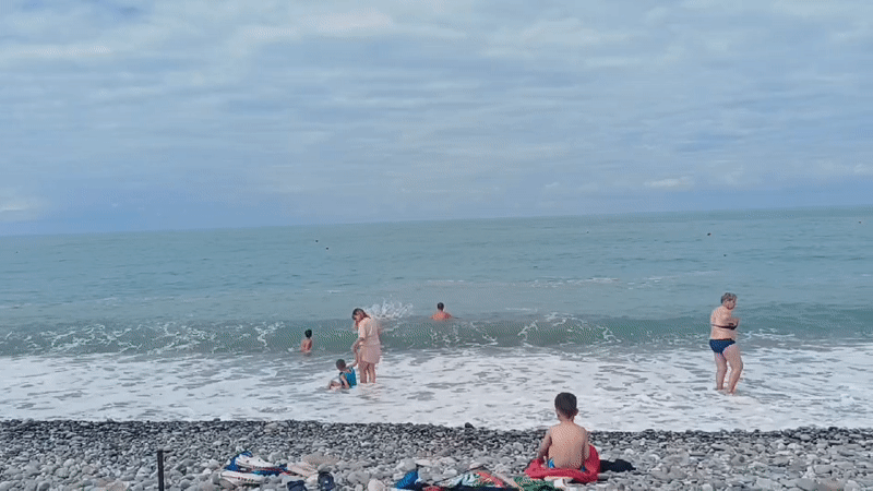 Morning beach scene in Sochi with swimmers and sunbathers