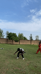 Two men perform backflips, acrobatics on lawn in Vom