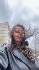 Woman photographed in windy conditions in Riga, Latvia