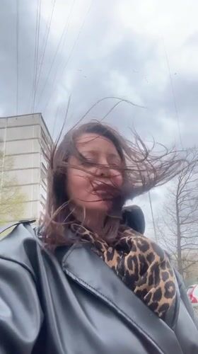 Woman photographed in windy conditions in Riga, Latvia