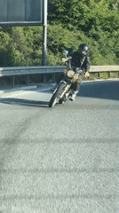 Motorcyclist rides vintage bike through Rafailovići, Montenegro