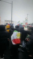 Crowd carries Iranian flags with lion emblem in Eqlid