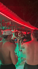 Young adults party at nighttime outdoor bar in Indonesia