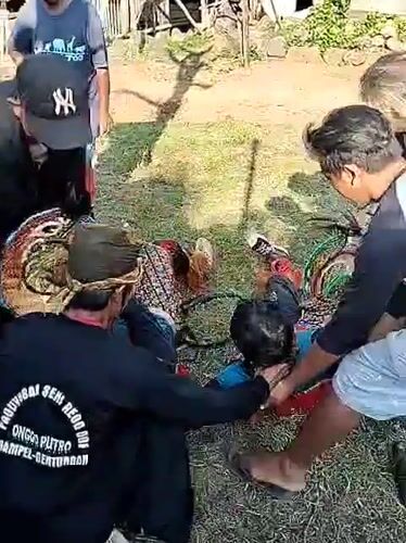 Traditional performer receives assistance during Indonesian cultural festival