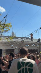 Crowd gathers at decorated outdoor venue for daytime event