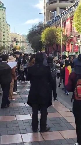 Large crowd walks through downtown La Paz streets