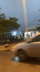 Wet streets reflect lights in Abuja after rain