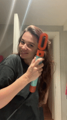 Woman dries hair with Dyson dryer in Belgrade bathroom