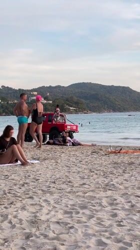 Beachgoers enjoy sunny day at Karon beach, Thailand