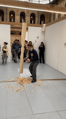 Artist demonstrates wood carving in Paris gallery space
