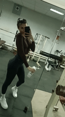 Woman takes indoor selfies during foggy spring afternoon
