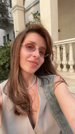 Woman takes selfie on modern Tel-Aviv patio