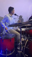 Drummer performs on red kit at Barcelona music venue