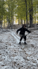 Man slides down snowy slope in Russian forest