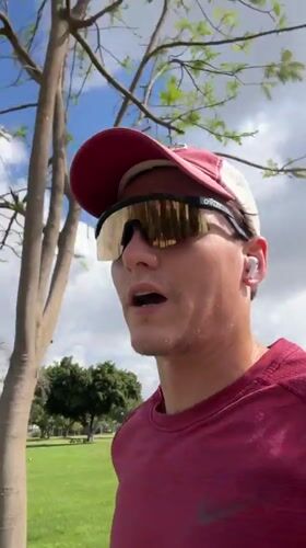 Man records video message on grassy field in Ramat Gan