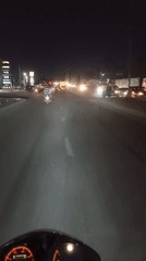 Motorcycle rider travels paved road in Dar es Salaam