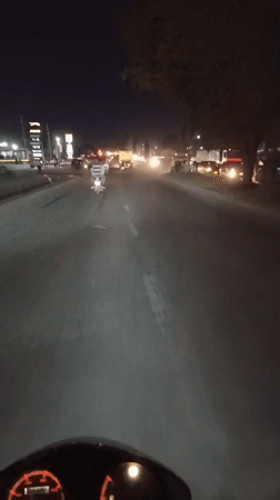 Motorcycle rider travels paved road in Dar es Salaam