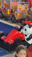 Kiddie rides light up at dusk in Budva, Montenegro