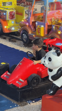 Kiddie rides light up at dusk in Budva, Montenegro