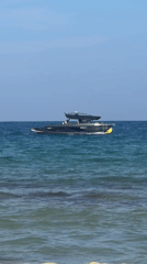 Sozopol coastline buzzing with water sports on a clear afternoon