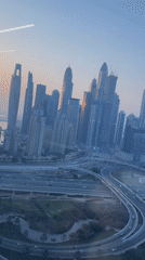 Dubai skyline at sunrise, skyscrapers catching early light