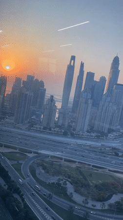 Dubai skyline at sunrise, skyscrapers catching early light