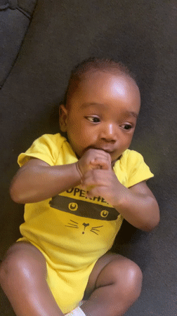 Baby observed swaddled in green towel in Nigerian village