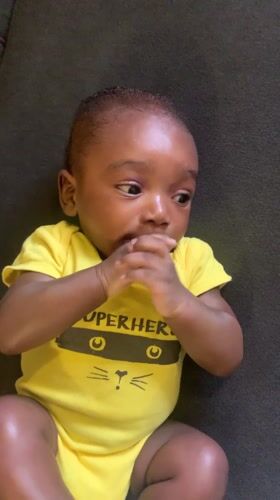 Baby observed swaddled in green towel in Nigerian village