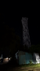 Nighttime scenes captured in Lhokseumawe: tower and pedestrian