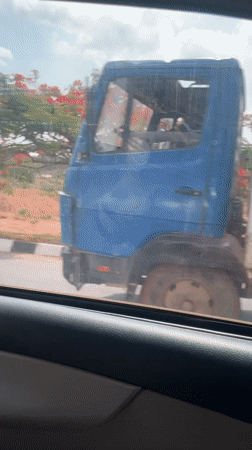 Vehicle passenger captures cloudy afternoon scenery in Gwarinpa, Nigeria