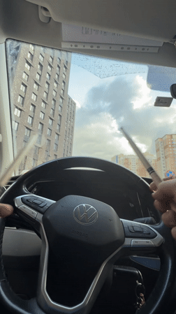 Driver plays drumsticks on steering wheel in Moscow Volkswagen