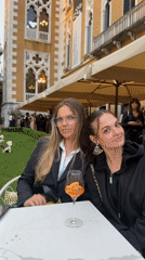 Women enjoy drinks near Chihuly Venice 2026 art exhibition