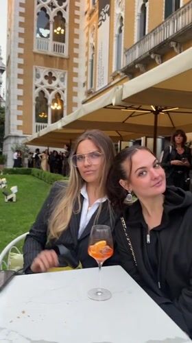 Women enjoy drinks near Chihuly Venice 2026 art exhibition